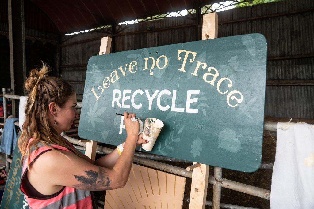 Artist painting Leave No Trace recycle point on an easel